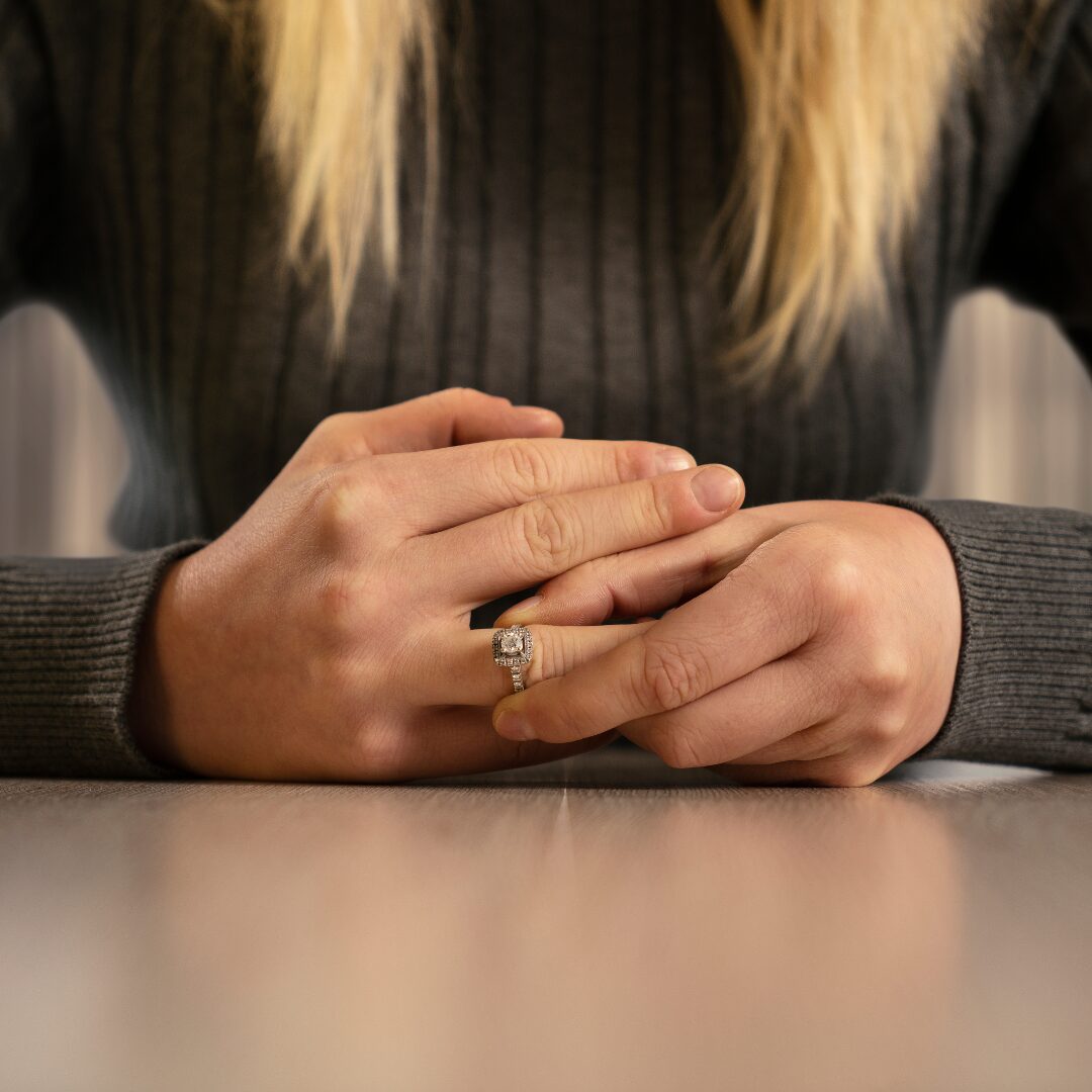 Taking off wedding ring.