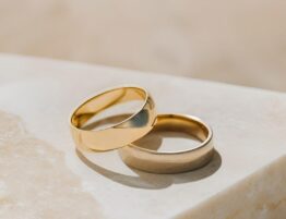 Two gold wedding rings indicating prenup and postnup agreements.